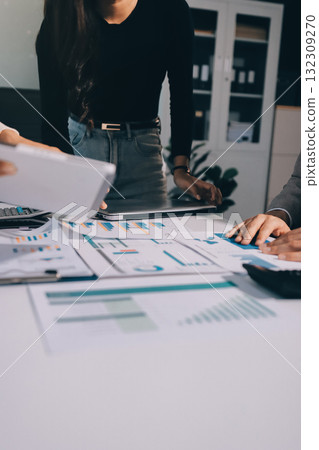Accounting company provide finance and taxation planning for profitable cash flow, Auditor and accountant team working in office, analyze financial data and accounting record with calculator.Insight Accounting company provide finance and taxation planning for profitable cash flow, Auditor and accountant team working in office, analyze financial data and accounting record with calculator.Insight 132309270