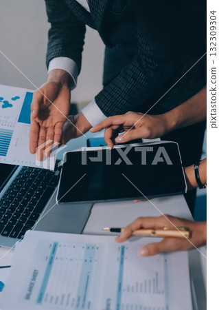 Accounting company provide finance and taxation planning for profitable cash flow, Auditor and accountant team working in office, analyze financial data and accounting record with calculator.Insight 132309304