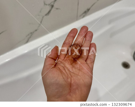 The problem of women's hair loss, women's hair on a girl's palm in the bathroom 132309674