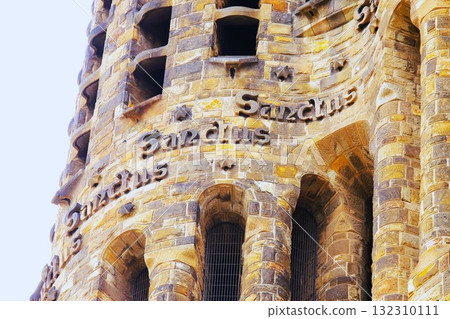 The Latin word "Sanctus" carved into the exterior wall of the Sagrada Familia The Latin word "Sanctus" carved into the exterior wall of the Sagrada Familia 132310111