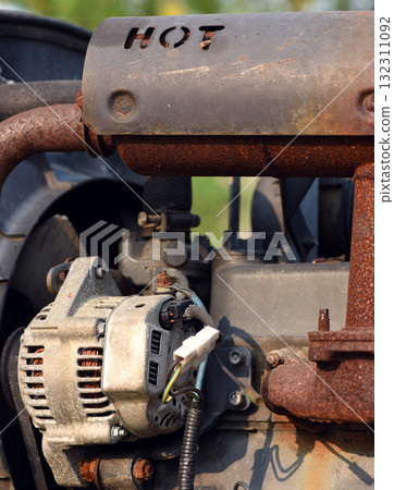 Close-up image of a rusty old engine that appears to be damaged in need of repair. 132311092