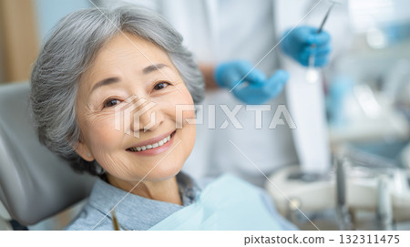Elderly woman smiling calmly during dental checkup 132311475