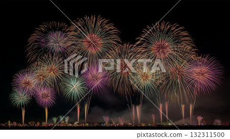 A large-scale fireworks display illuminated by sea mist 132311500
