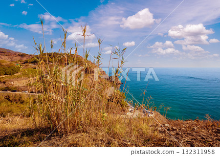 Seascape on a sunny day. Steep seashore. View from  Maro Beach Viewpoint. Nerja, Spain 132311958