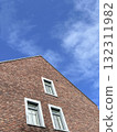 red brick building with white windows over sky 132311982
