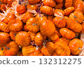A vibrant pile of small orange pumpkins celebrates the autumn harvest and holidays 132312275