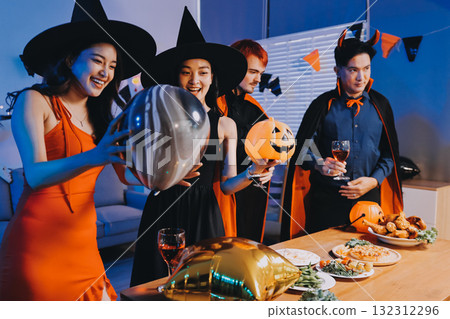 Joyful office Halloween party with coworkers in costumes, celebrating with drinks and laughter, fostering teamwork and festive spirit 132312296