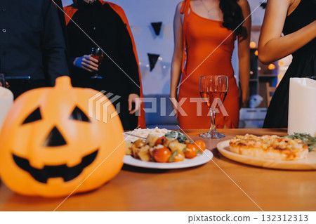 Joyful office Halloween party with coworkers in costumes, celebrating with drinks and laughter, fostering teamwork and festive spirit 132312313