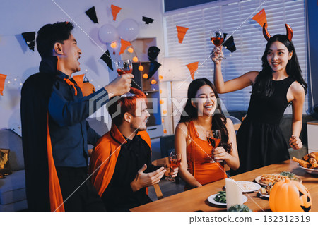 Joyful office Halloween party with coworkers in costumes, celebrating with drinks and laughter, fostering teamwork and festive spirit 132312319