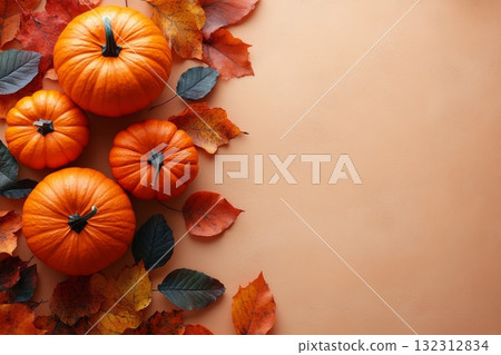 Row of pumpkins and autumn leaves on table 132312834