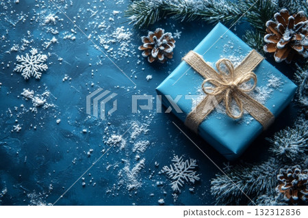 Blue gift box, brown ribbon on blue background with snowflakes and pine cones 132312836