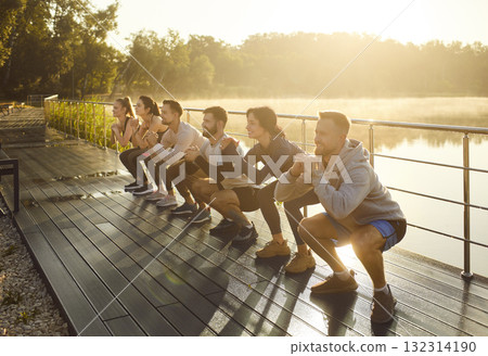 Positive Team Doing Squats In City Park 132314190