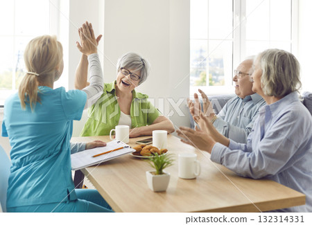 A nurse in a nursing home communication with elderly people, close-up A nurse in a nursing home communication with elderly people, close-up 132314331