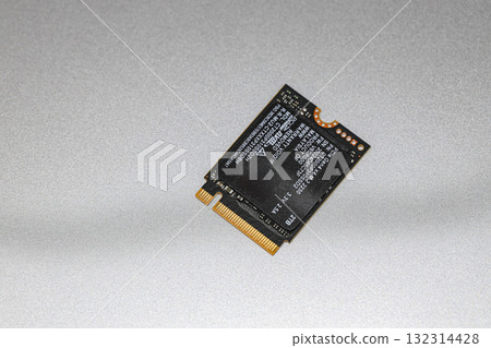 NVME PCIe solid-state drive in the M.2 2230 form factor isolated on metal background. 132314428