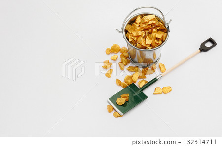 Small metal bucket filled with golden stones on white background. Concept of wealth 132314711