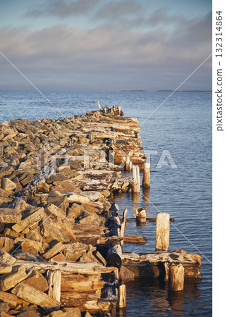 A ruined wooden pier on the blue sea 132314864