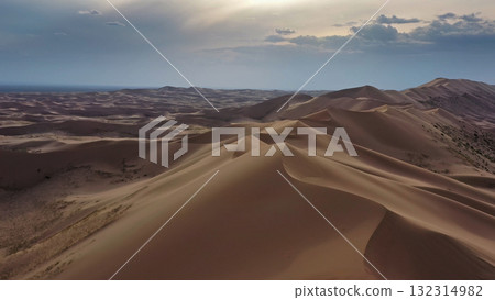 Aerial view of sand dunes in desert at sunset 132314982