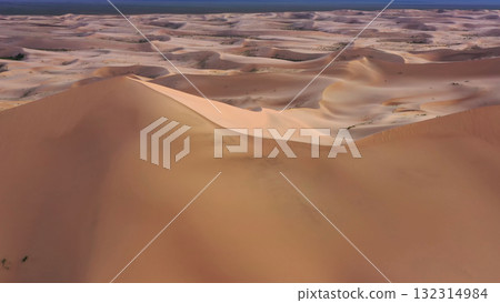 Aerial view of sand dunes in desert at sunset 132314984