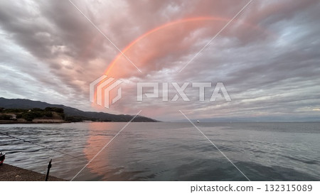 Rainbow in the morning glow over the sea 132315089
