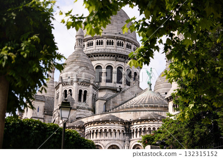Sacre Coeur Basilica in Montmartre Paris France framed by trees 132315152