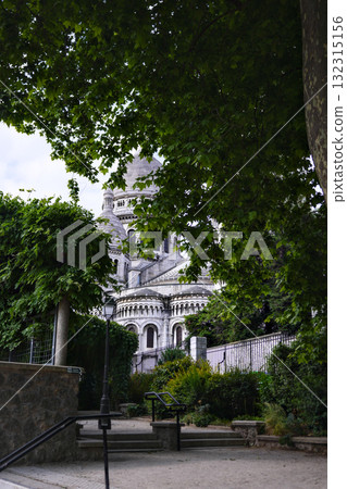 Sacre Coeur Basilica in Montmartre Paris framed by green trees Sacre Coeur Basilica in Montmartre Paris framed by green trees 132315156