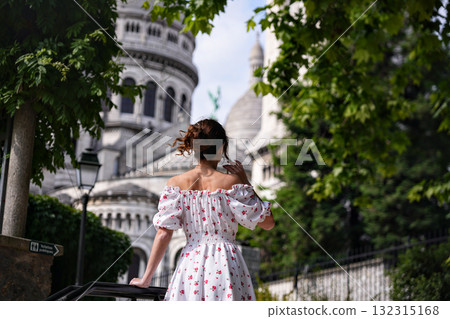 Young woman in floral dress walking near Sacre Coeur Basilica in Paris Young woman in floral dress walking near Sacre Coeur Basilica in Paris 132315168