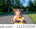 Scooter child. Girl riding scooter toddler. Yellow outdoor activity park road. 132315559
