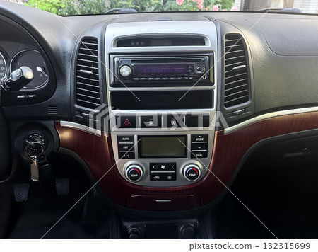 Dashboard display showcases modern car controls and features in a sleek interior on a sunny day 132315699