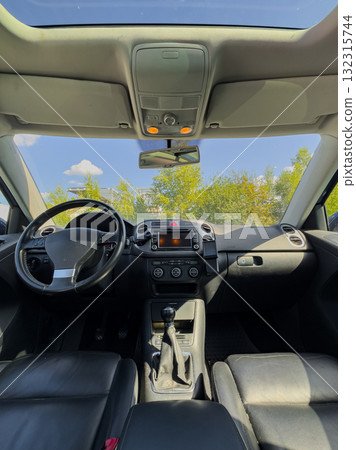 Inside a modern vehicle showing sleek interior design and clear blue sky, sunlight streaming through windows on a peaceful day Inside a modern vehicle showing sleek interior design and clear blue sky, sunlight streaming through windows on a peaceful day 132315744