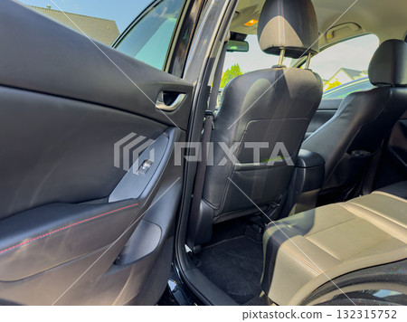 Exploring the interior of a sleek modern car parked in a sunny suburban driveway on a clear day Exploring the interior of a sleek modern car parked in a sunny suburban driveway on a clear day 132315752