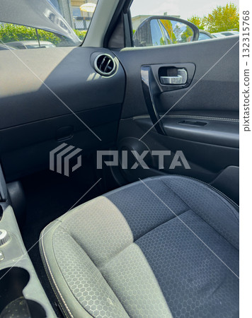 Interior view of a modern vehicle with a focus on the driver's seat and dashboard 132315768