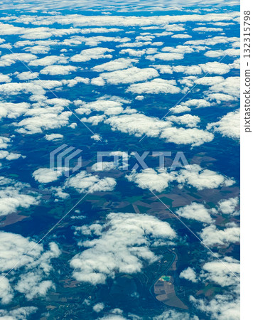 Rich landscapes under a quilt of clouds captured from above during a bright, sunny day in early autumn in the countryside 132315798