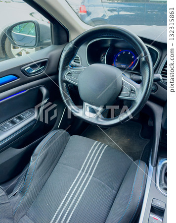 Modern car interior with sleek design and blue accents creating a comfortable and stylish driving experience on a sunny day Modern car interior with sleek design and blue accents creating a comfortable and stylish driving experience on a sunny day 132315861
