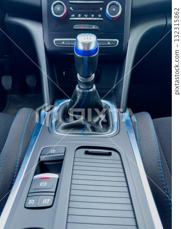 Showcase of a modern car interior with a stylish gear shifter and sleek console design in a contemporary vehicle setting 132315862