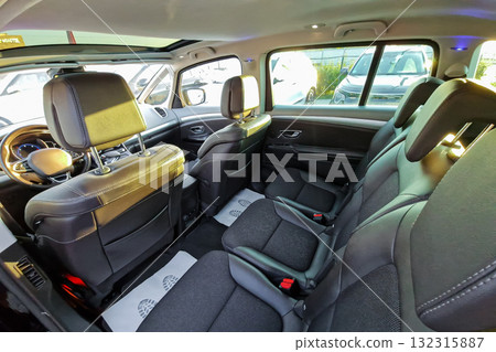 Spacious interior of a modern vehicle showcasing comfortable seating arrangement and clean design in bright daylight Spacious interior of a modern vehicle showcasing comfortable seating arrangement and clean design in bright daylight 132315887