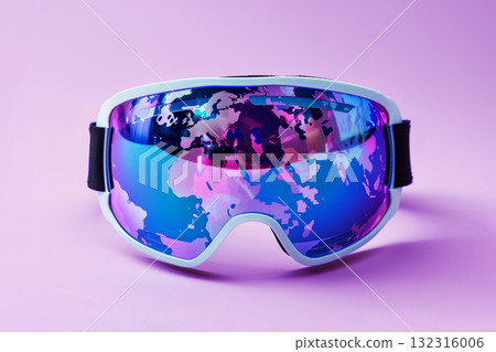 Reflective ski goggles showing silhouette of world map on lenses, concept of global travel and winter adventure. 132316006