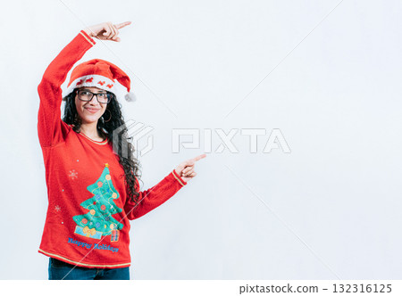 Happy young woman in Christmas sweater recommending and pointing aside. Smiling girl in Christmas sweater pointing to the side, isolated 132316125