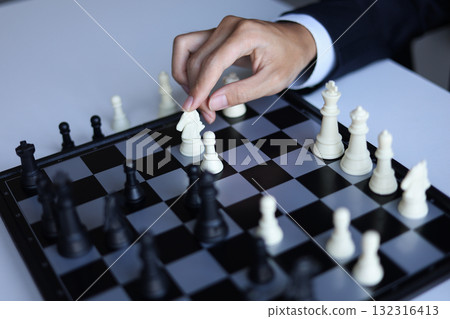 Businessman playing chess game; business strategy, leadership and management concept. 132316413