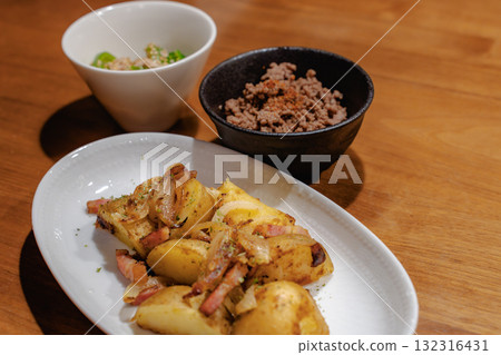 A home-style dinner with sautéed bacon and potatoes as the main dish A home-style dinner with sautéed bacon and potatoes as the main dish 132316431