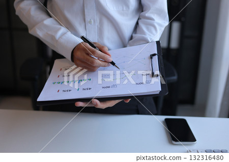 Businessman working in office reading documents analyze data for project planning. 132316480