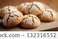 A delicious, soft-focus close-up photograph showcasing a pile of traditional Maghrebi Ghriba cookies, also known as Ghraiba or Ghorayeba.  132316552