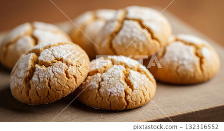 A delicious, soft-focus close-up photograph showcasing a pile of traditional Maghrebi Ghriba cookies, also known as Ghraiba or Ghorayeba. A delicious, soft-focus close-up photograph showcasing a pile of traditional Maghrebi Ghriba cookies, also known as Ghraiba or Ghorayeba. 132316552