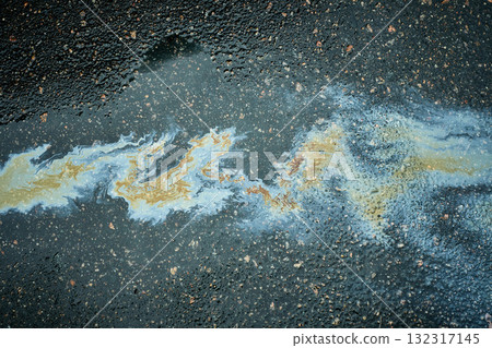 Polluting oil slick spreading on wet asphalt pavement 132317145