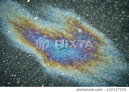 Iridescent oil spill creating abstract rainbow on wet asphalt 132317150