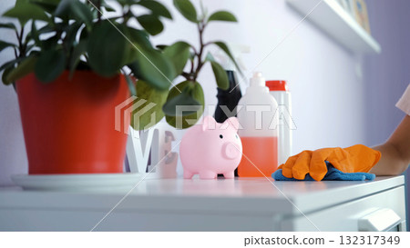 Teen girl wipes drawer with blue rag in her room maintaining cleanliness and order 132317349