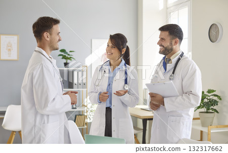 Medical staff of doctors standing in clinic and talking during a meeting in hospital. Medical staff of doctors standing in clinic and talking during a meeting in hospital. 132317662