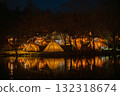 The light of the tent reflected on the water at night 132318674