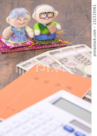 Elderly couple and pension book (+money) 132319361