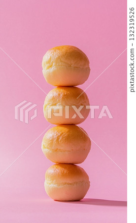 Fried bread stack arranged up in pink vertical background 132319526