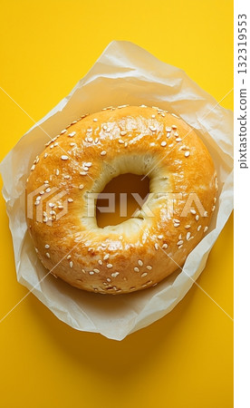 Bagel with sesame on paper wrap simple breakfast food in solid yellow background 132319553
